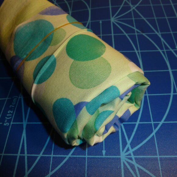 Fabric with an asymmetrical pattern of white, blue, and green bubbles - Picture 2 of 3